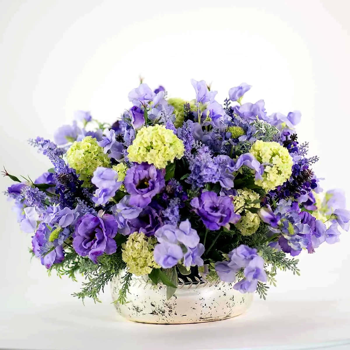 Luxury faux flower and plant arrangement by Pulbrook & Gould, London