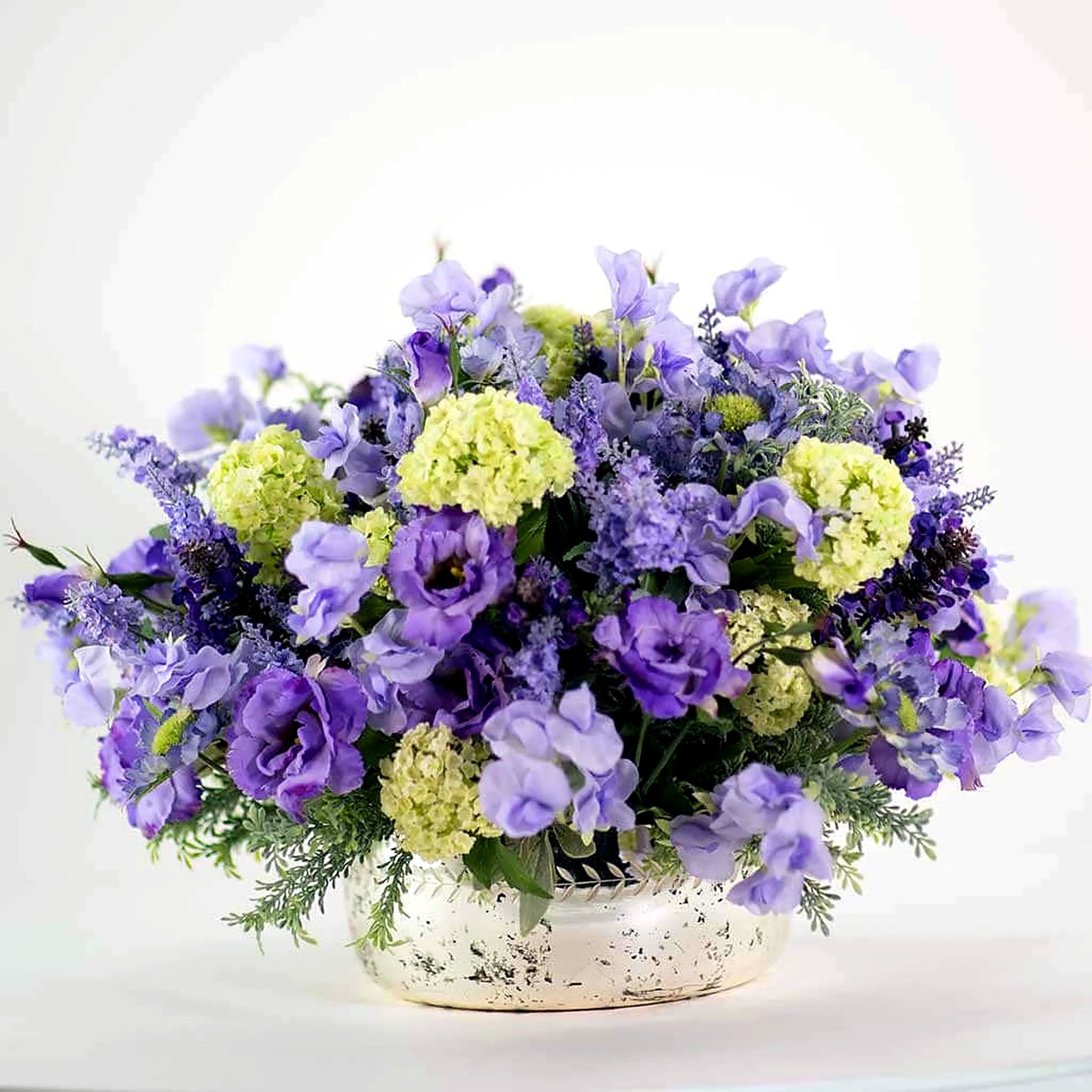 Luxury faux flower and plant arrangement by Pulbrook & Gould, London