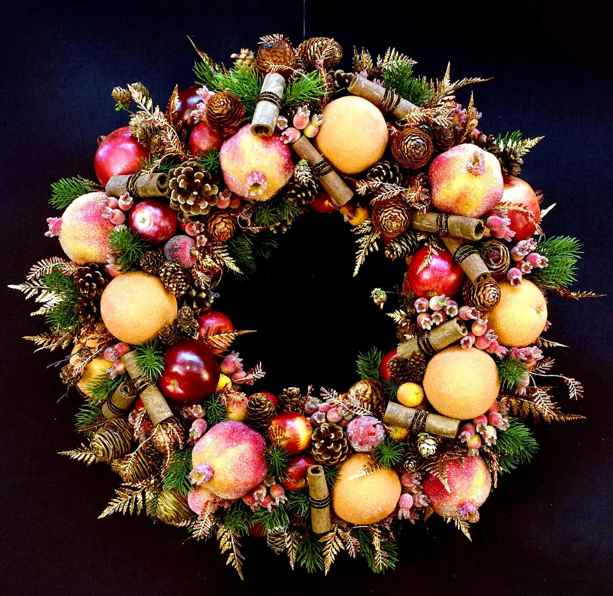 Christmas wreath with pomegranates, pinecones and cinnamon by Pulbrook & Gould