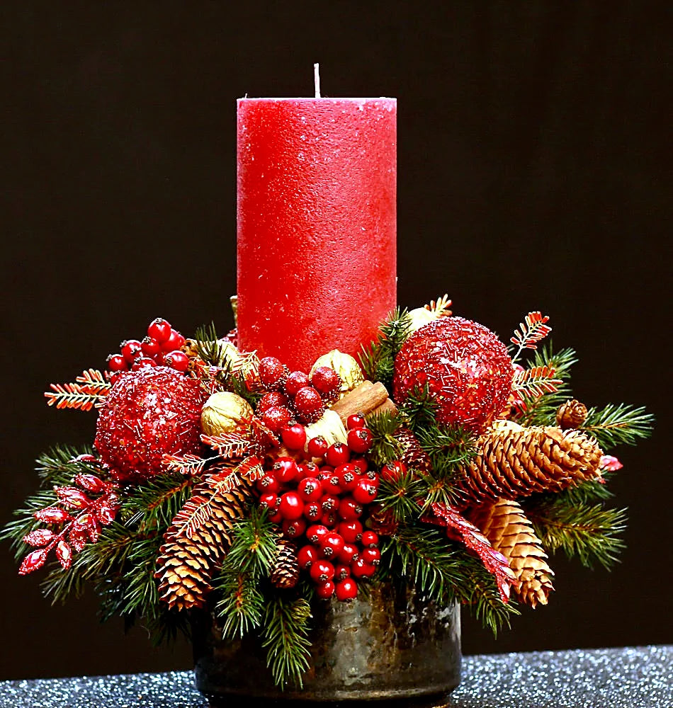 Red Christmas candle centrepiece with berries, pinecones and gold baubles by Pulbrook & Gould
