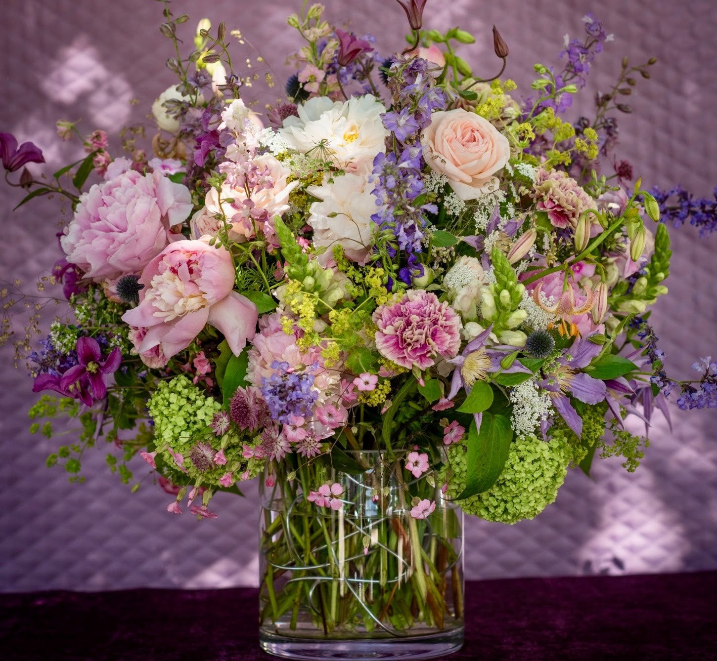 Seasonal vase arrangement of peonies, sweet peas and spring blooms