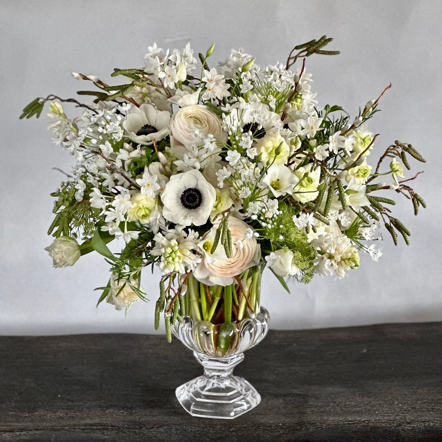 Jane bouquet by Pulbrook & Gould — a hand-tied arrangement of white anemones, ranunculus, and narcissi with soft greenery