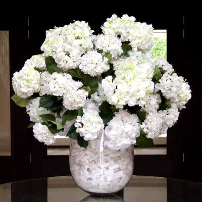 
                    
                      Large Faux White Hydrangea Arrangement by Pulbrook Gould in glass vessel with selenite accents
                    
                  