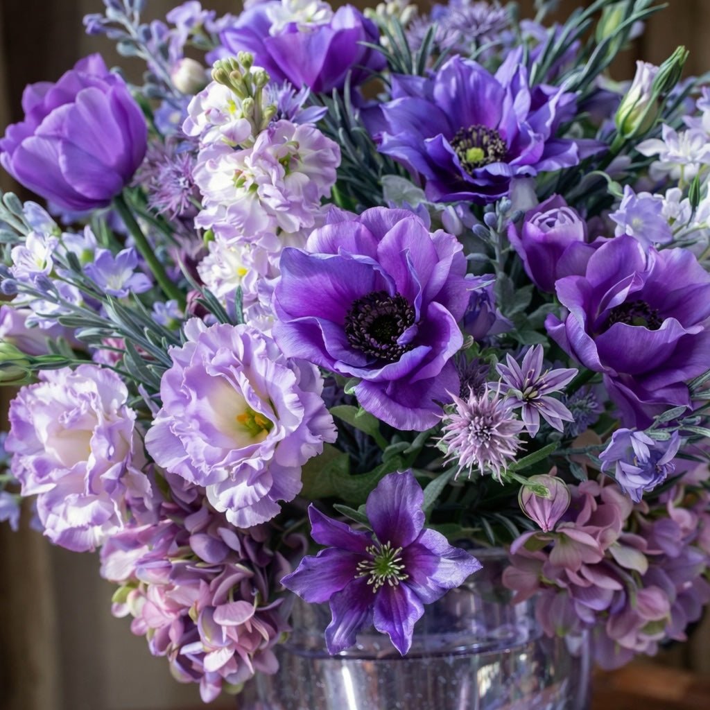 Bouquet of purple and pink flowers in a silver bucket