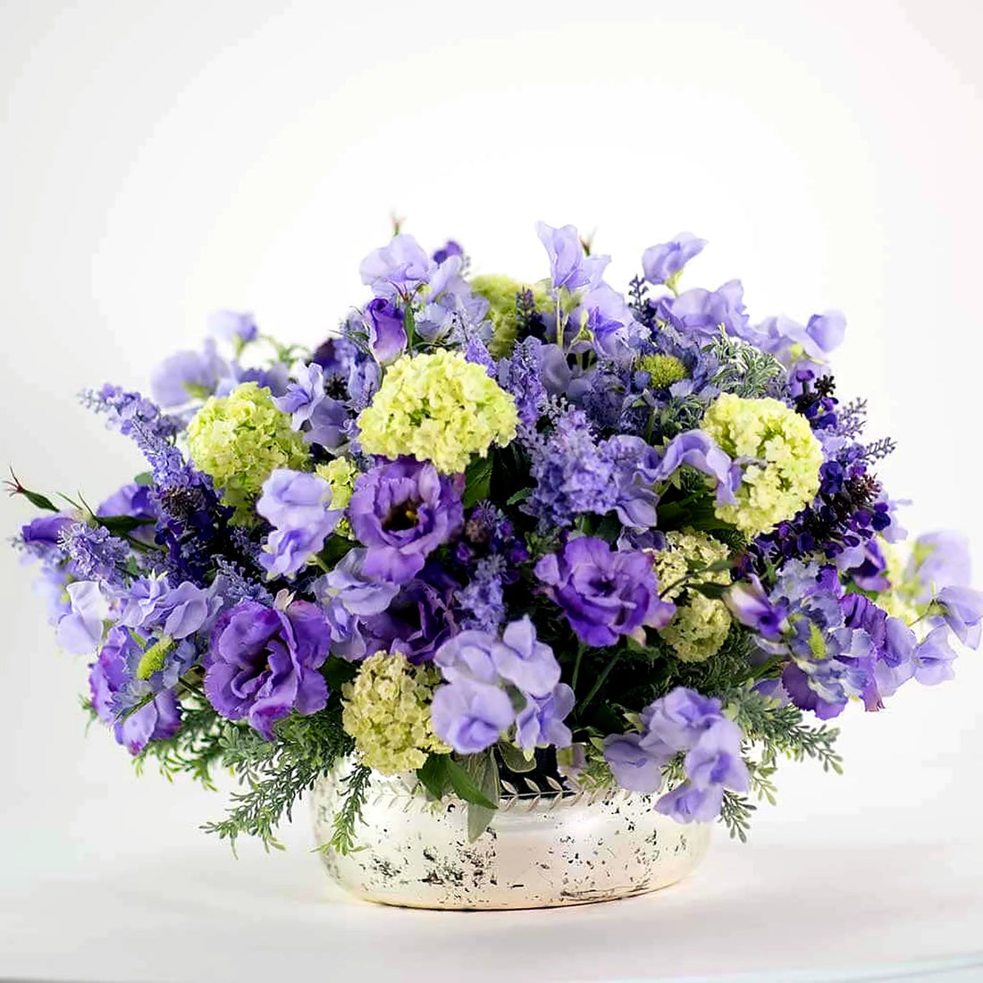 Mixed Silk Summer Blues Pulbrook and Gould faux silk floral arrangement in a clear glass vase with blue and green blooms