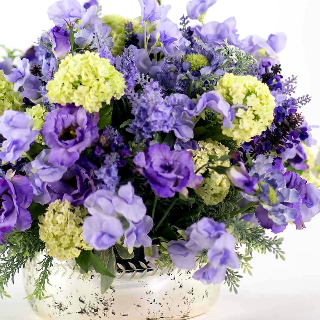 Mixed Silk Summer Blues by Pulbrook Gould faux floral arrangement in a clear glass vase with blue tones