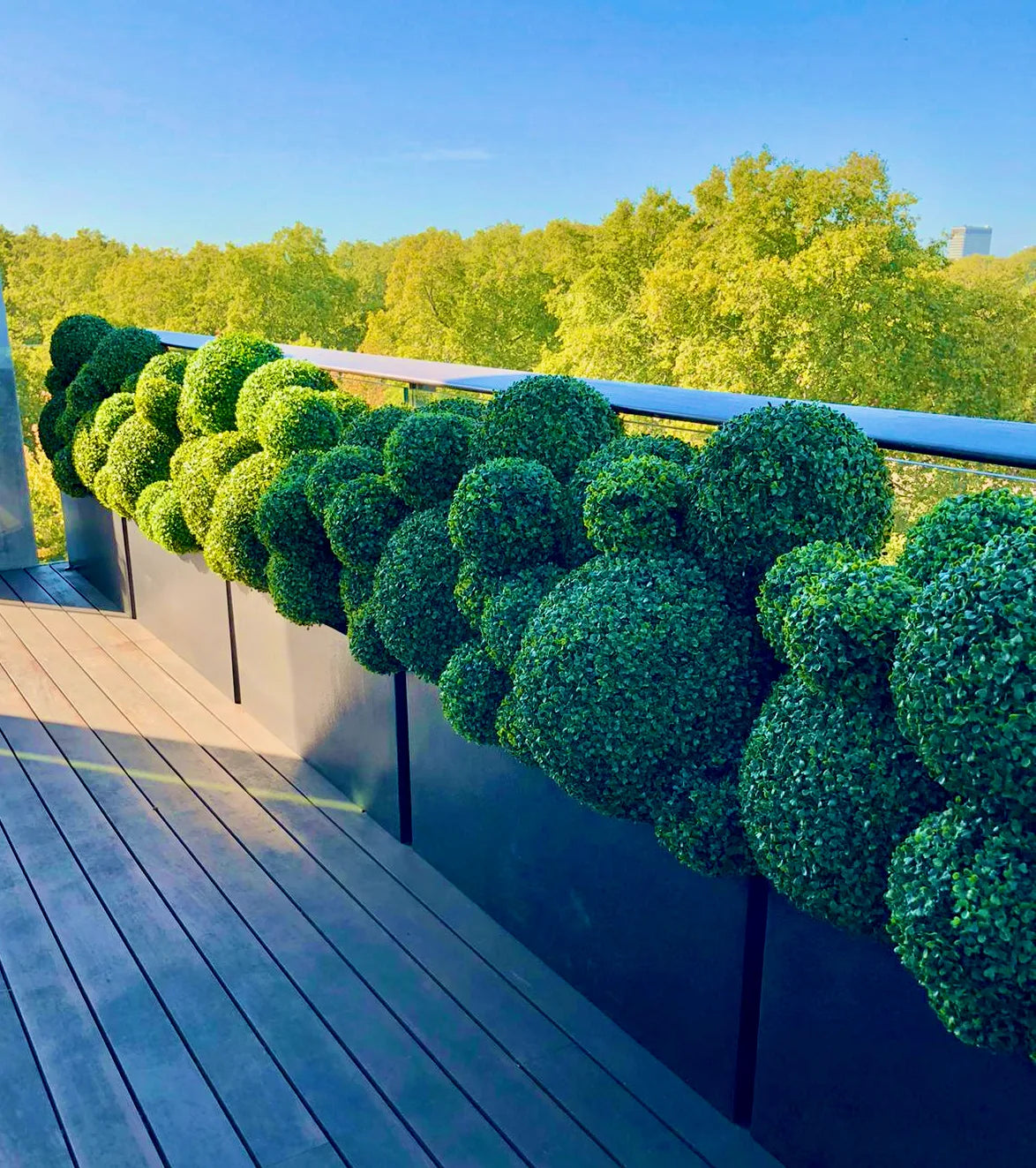 Styled outdoor terrace with lush planting by Pulbrook & Gould, London