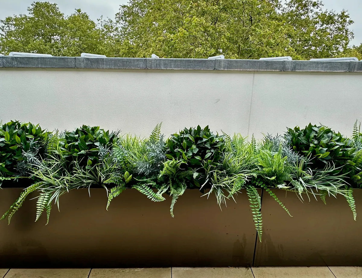 Potted plants styled on a London balcony by Pulbrook & Gould