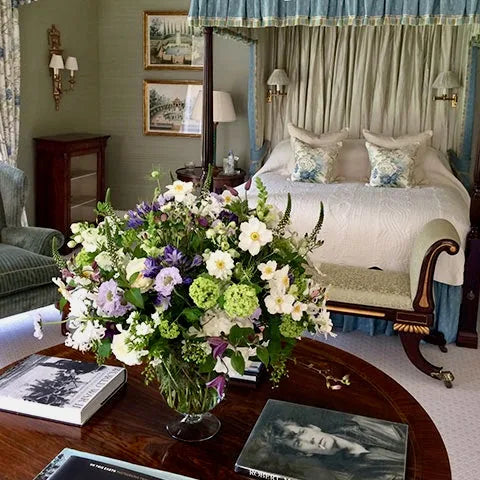 White and purple flower arrangement in a private London bedroom by Pulbrook & Gould