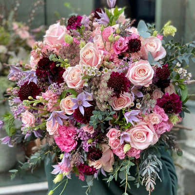 
                    
                      Radiant Pastels hand-tied bouquet in soft pink and burgundy with rose and scabiosa mix
                    
                  