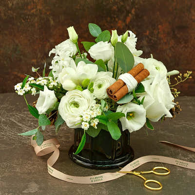 
                    
                      Seasonal Vase Arrangement Class, white flower bouquet with cinnamon sticks in a dark vase
                    
                  