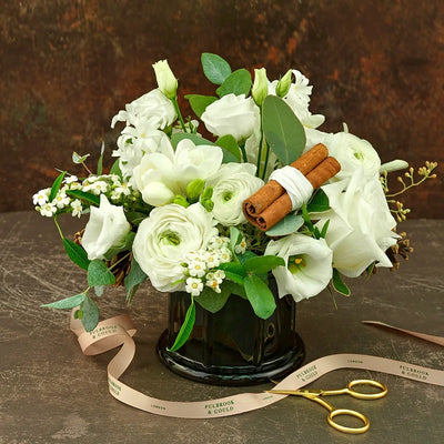 
                    
                      Seasonal Vase Arrangement Class by Pulbrook Gould, white flower bouquet with cinnamon sticks in a dark vase
                    
                  