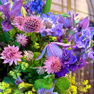 
                    
                      Summer Blues Pulbrook and Gould hand tied bouquet in purple and blue with larkspur, stocks and clematis
                    
                  