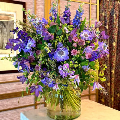 
                    
                      Summer Blues Pulbrook and Gould hand tied bouquet in blue and purple with clematis, larkspur and scabiosa
                    
                  