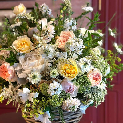 
                    
                      Summer Charm by Pulbrook and Gould garden basket floral arrangement with cream, peach and yellow blooms
                    
                  