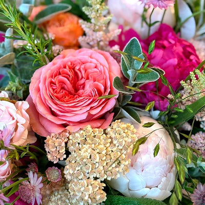 
                    
                      Summer Joy by Pulbrook and Gould hand-tied bouquet in pink and fuchsia with leafy foliage and achillea accents
                    
                  