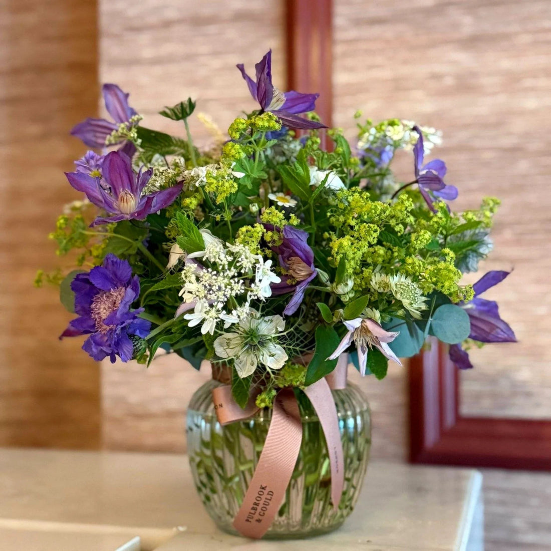 Summer Posy by Pulbrook and Gould hand tied posy bouquet with purple clematis and lime green flowers