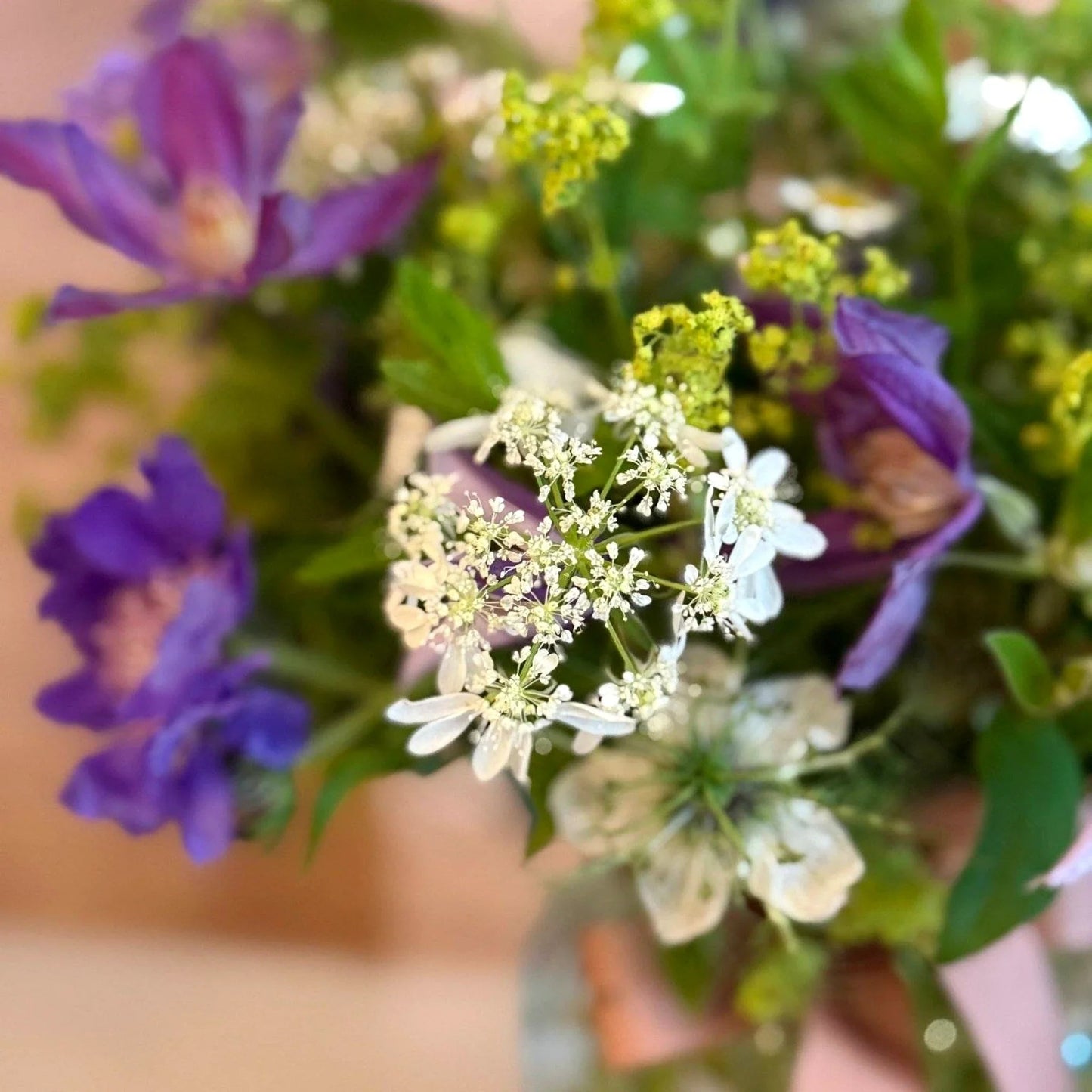 Summer Posy by Pulbrook Gould hand-tied posy bouquet with purple clematis and white fresh-cut blooms