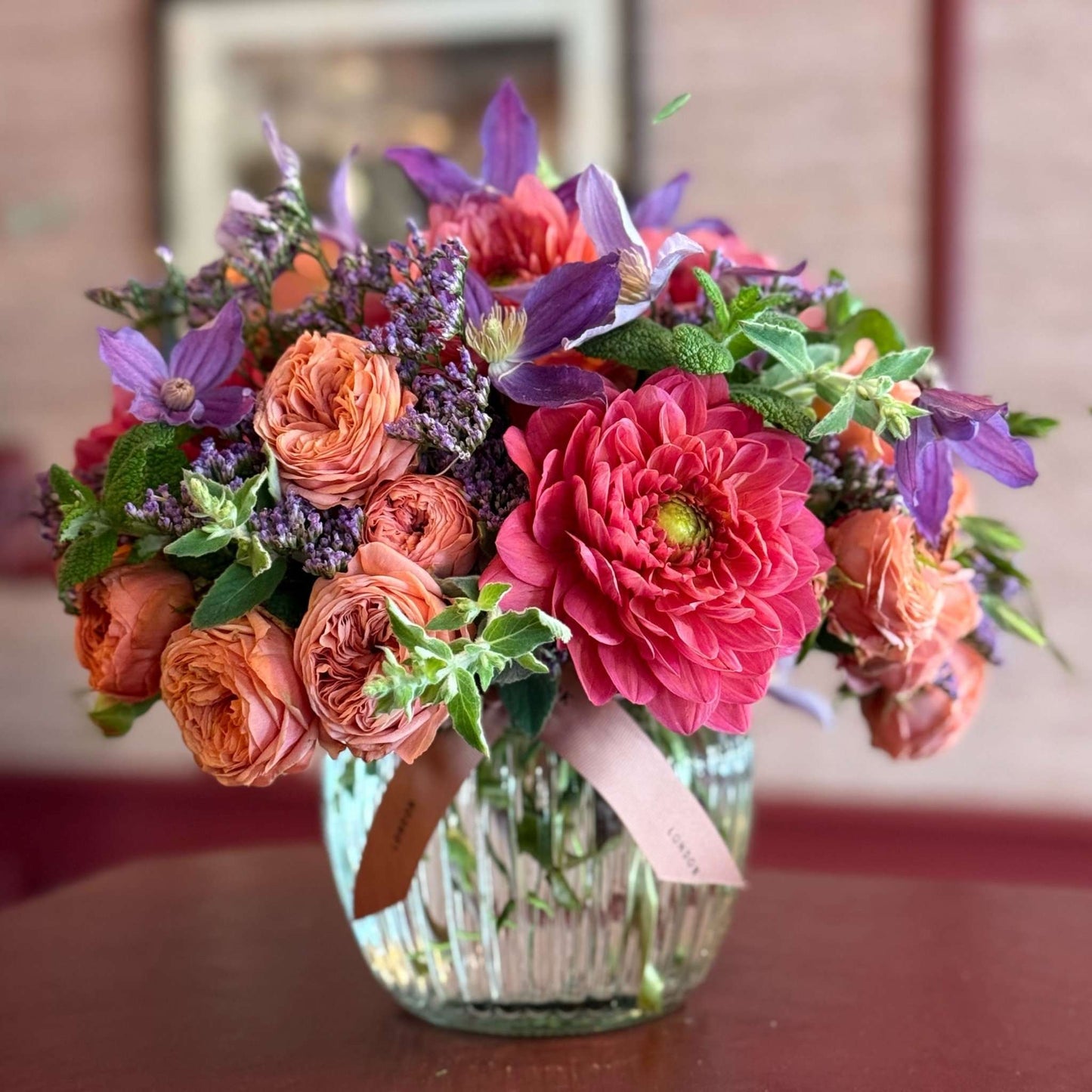 Summer Thrills Posy featuring soft peach spray roses, vibrant dahlias and clematis with purple sea lavender, by Pulbrook & Gould London