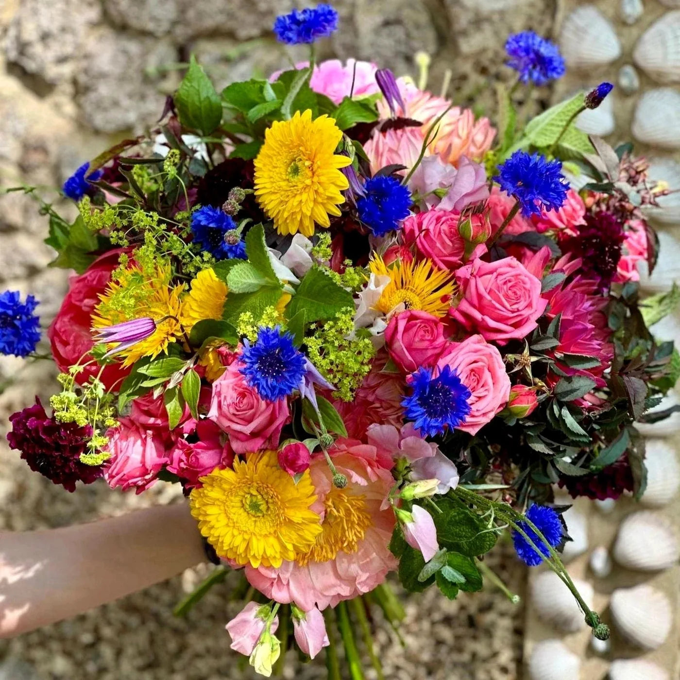 Summer Vibrations by Pulbrook and Gould hand tied bouquet with pink roses, blue cornflowers and yellow gerberas