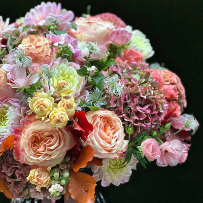 
                    
                      The Beaufort by Pulbrook and Gould hand-tied bouquet and vase arrangement in pink, cream and green with autumn foliage
                    
                  