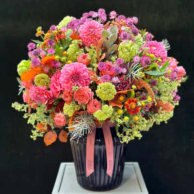 
                    
                      The Kent hand tied bouquet in bright pink orange and green with dahlias and astrantia
                    
                  