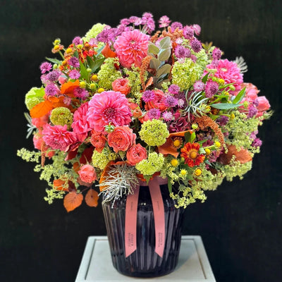 
                    
                      The Kent by Pulbrook Gould hand tied bouquet in bright pink orange and green with dahlias and astrantia
                    
                  