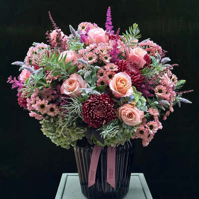 
                    
                      The Montrose hand-tied bouquet in soft pink and deep burgundy with mint sprigs
                    
                  