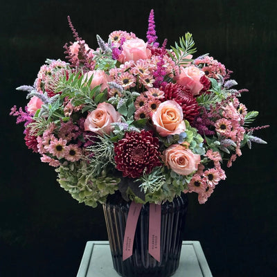 
                    
                      The Montrose by Pulbrook and Gould hand-tied bouquet in soft pink and deep burgundy with mint sprigs
                    
                  