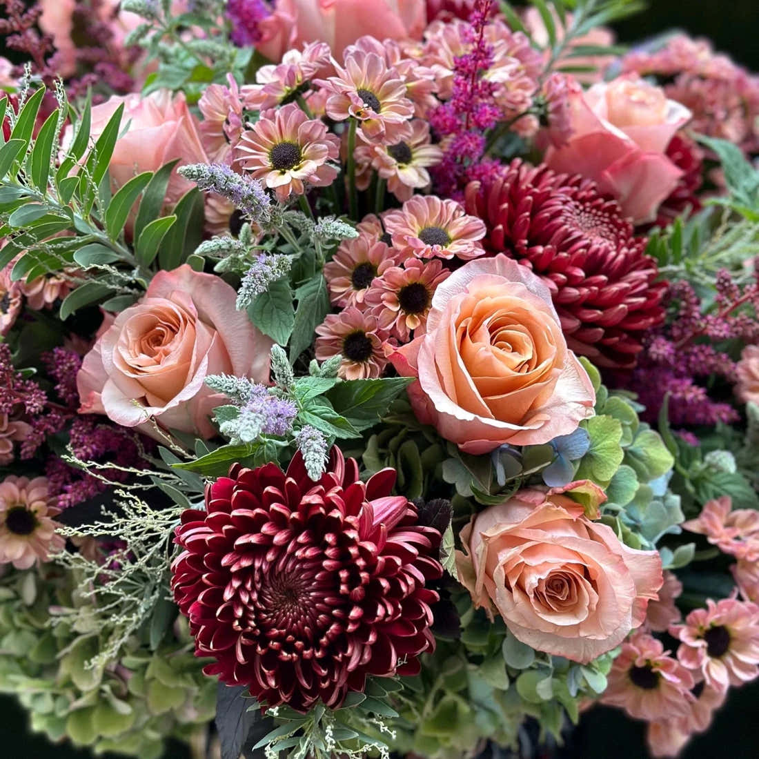 The Montrose by Pulbrook and Gould hand-tied bouquet in blush pink, rose and purple with mint sprigs