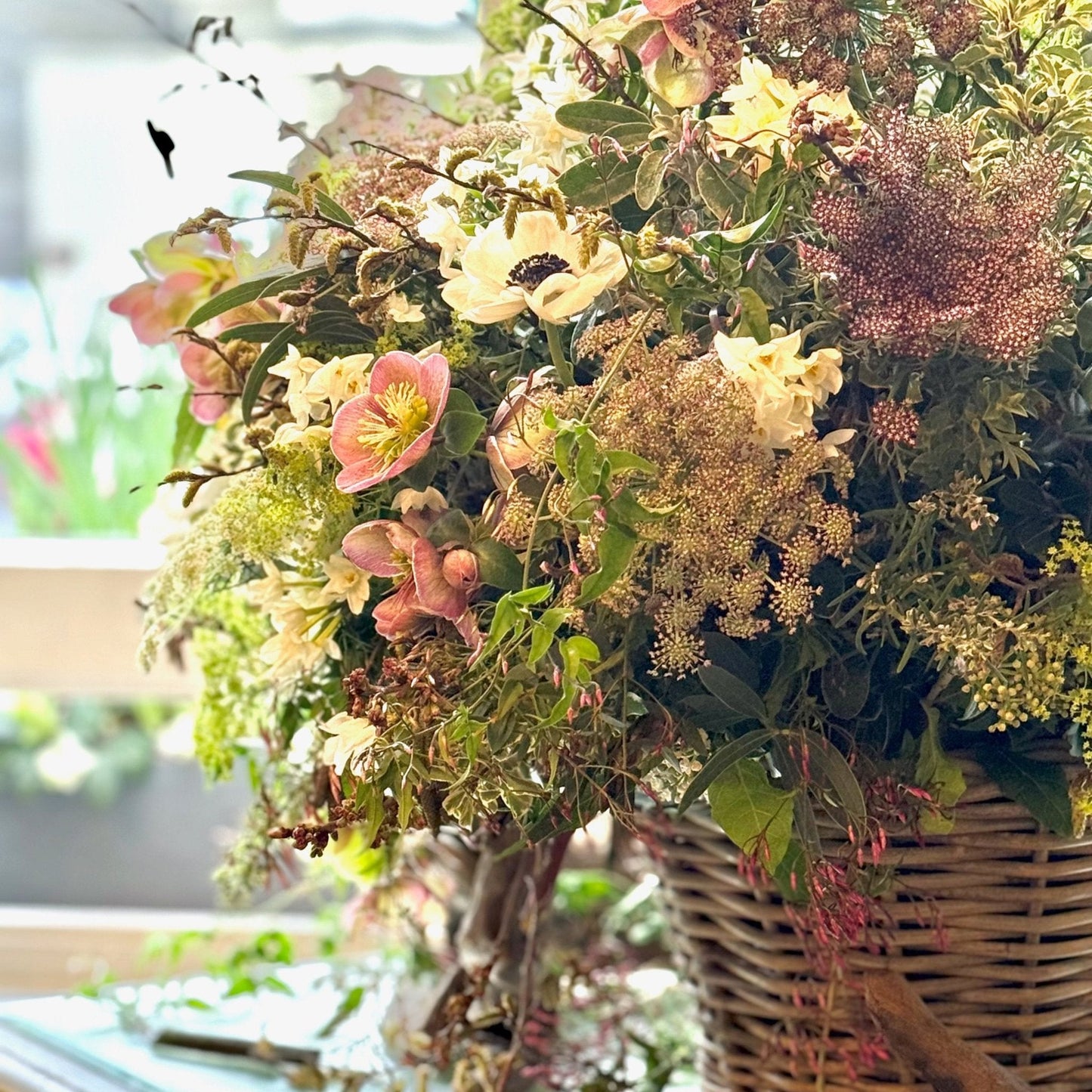 Bouquet of flowers in a woven basket with blurred background