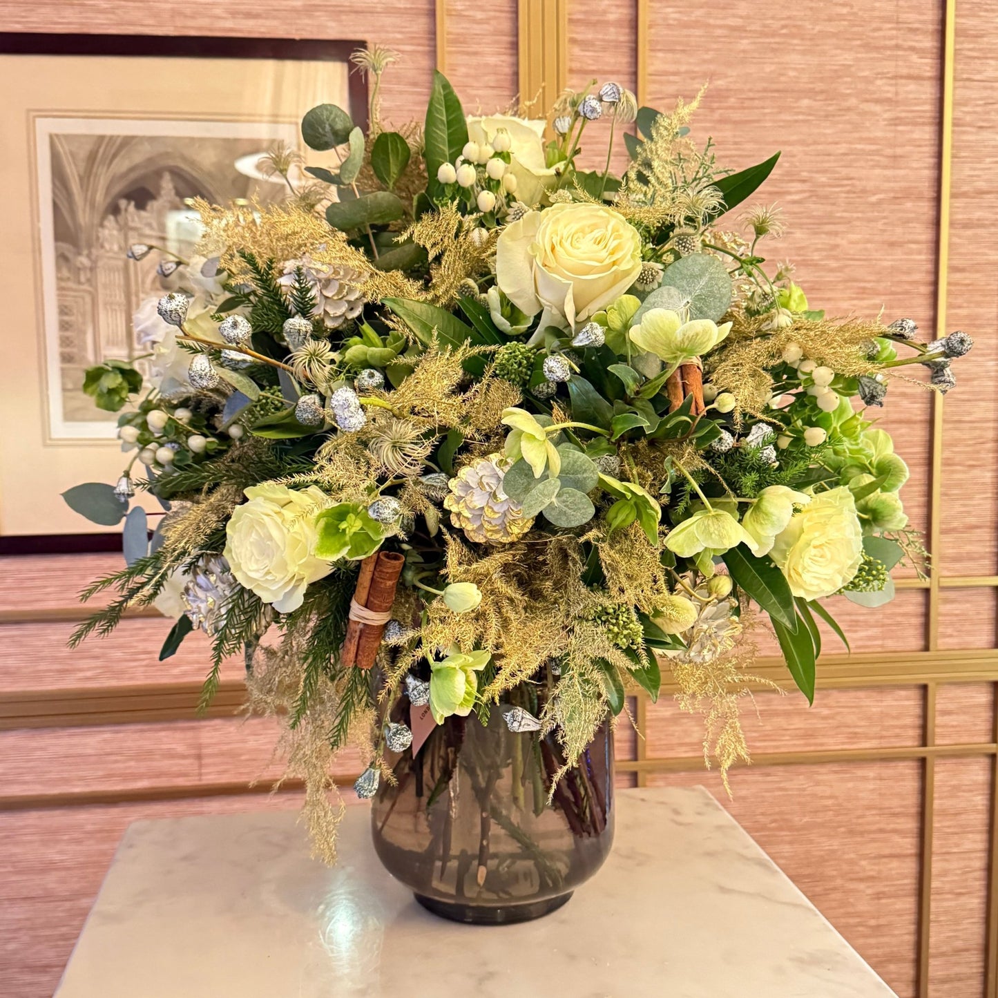 Decorative floral arrangement in a vase against a wooden panel background