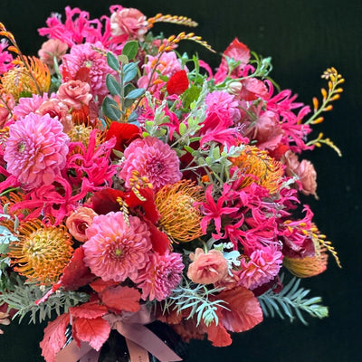 
                    
                      The Rutland by Pulbrook Gould hand tied bouquet and vase arrangement in pink and red autumn blooms
                    
                  