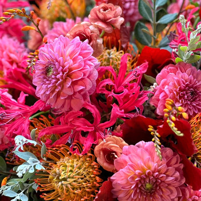 
                    
                      The Rutland by Pulbrook and Gould hand tied bouquet and vase arrangement in pink and coral autumn florals
                    
                  