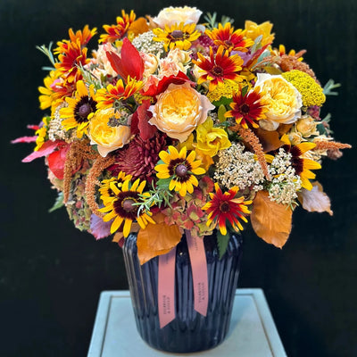 
                    
                      The Windsor Pulbrook and Gould hand tied bouquet arrangement in autumn colours with bright sunflower heads
                    
                  