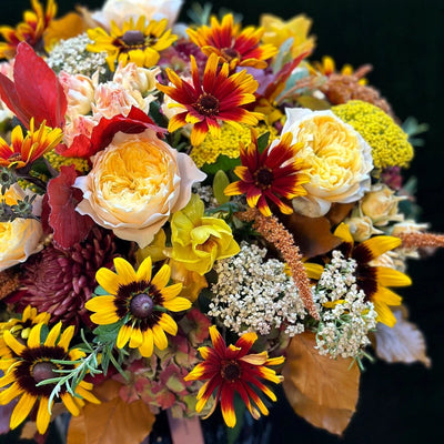 
                    
                      The Windsor by Pulbrook Gould autumn themed hand tied bouquet arrangement with yellow, red and cream flowers
                    
                  
