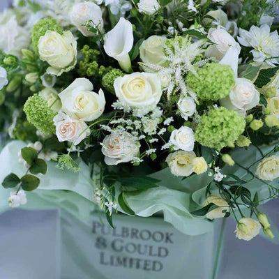 
                    
                      Timeless Whites by Pulbrook and Gould hand tied bouquet in white with fresh cut roses and calla lilies
                    
                  