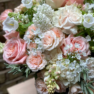 
                    
                      Victoria Pulbrook Gould hand tied bouquet in pastel pink, white and peach with fresh freesias and roses
                    
                  