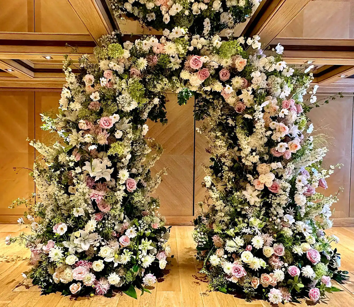 Blush rose and white floral wedding arch by Pulbrook & Gould