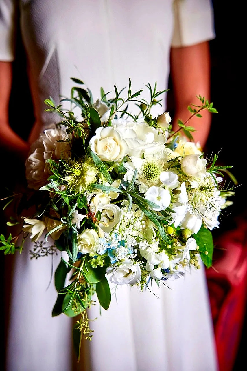 White and cream bridal bouquet with roses and foliage by Pulbrook & Gould