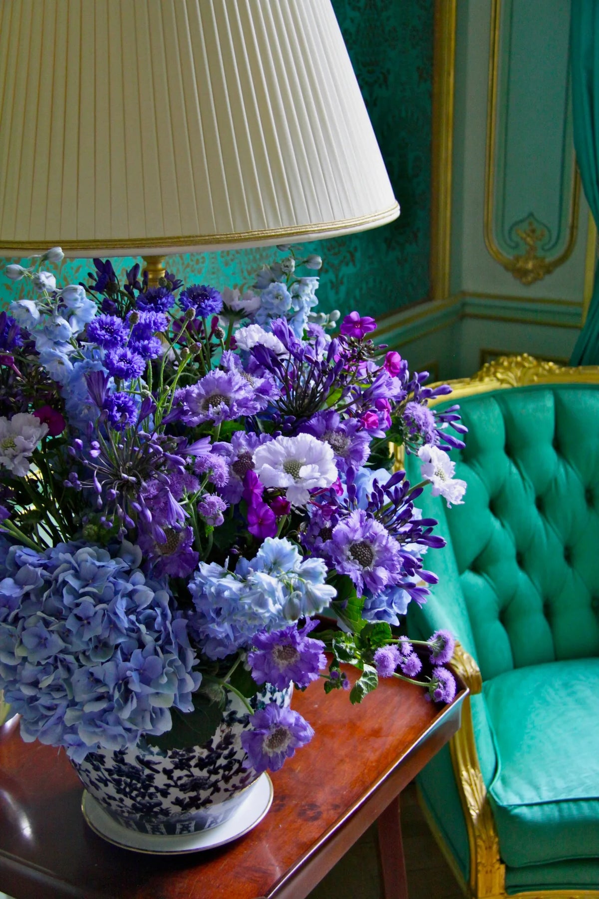 Blue and purple flower arrangement in a chinoiserie vase on a side table, weekly flowers for London homes by Pulbrook & Gould