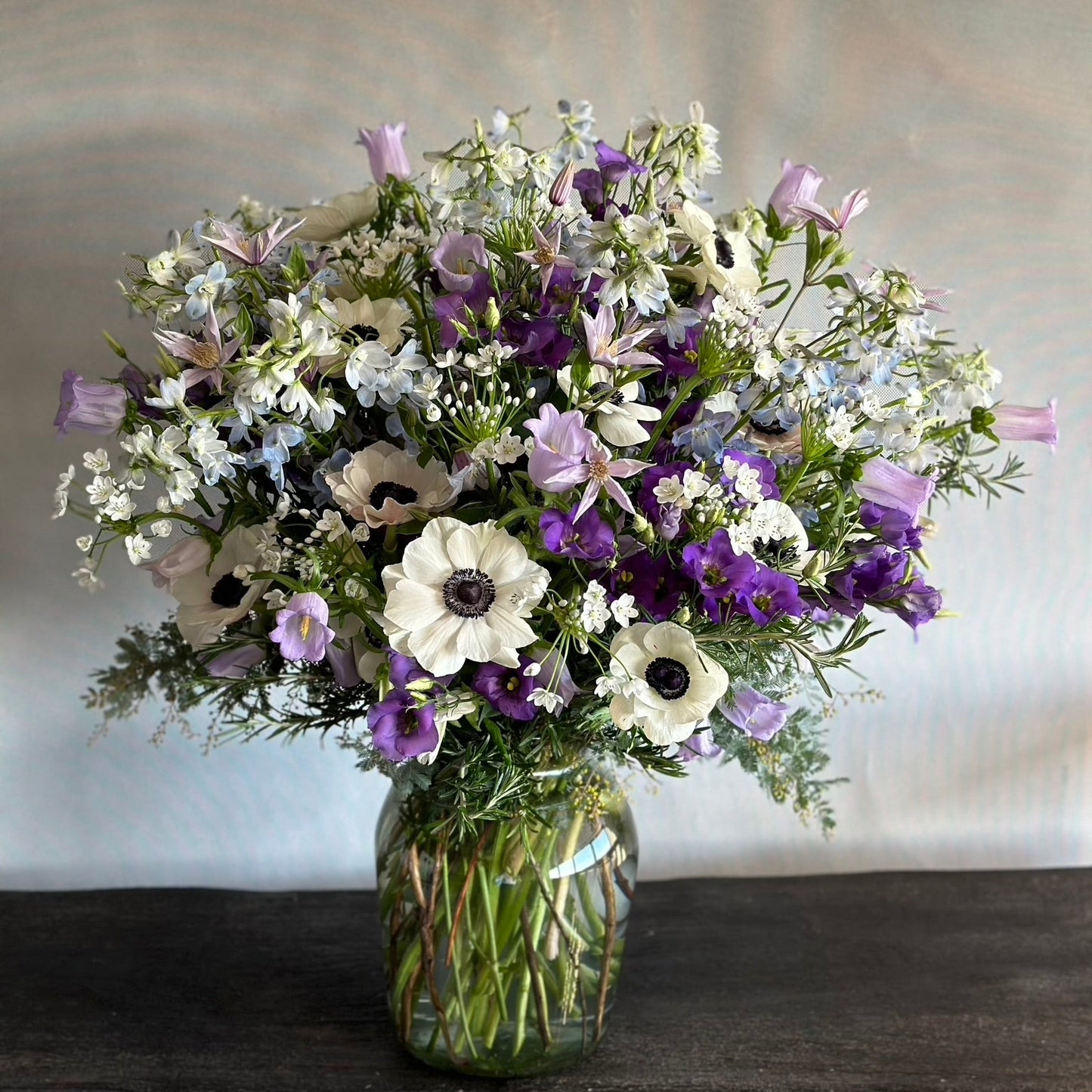 Florence Mother's Day bouquet by Pulbrook & Gould — deep purple agapanthus, anemones and springtime blooms.