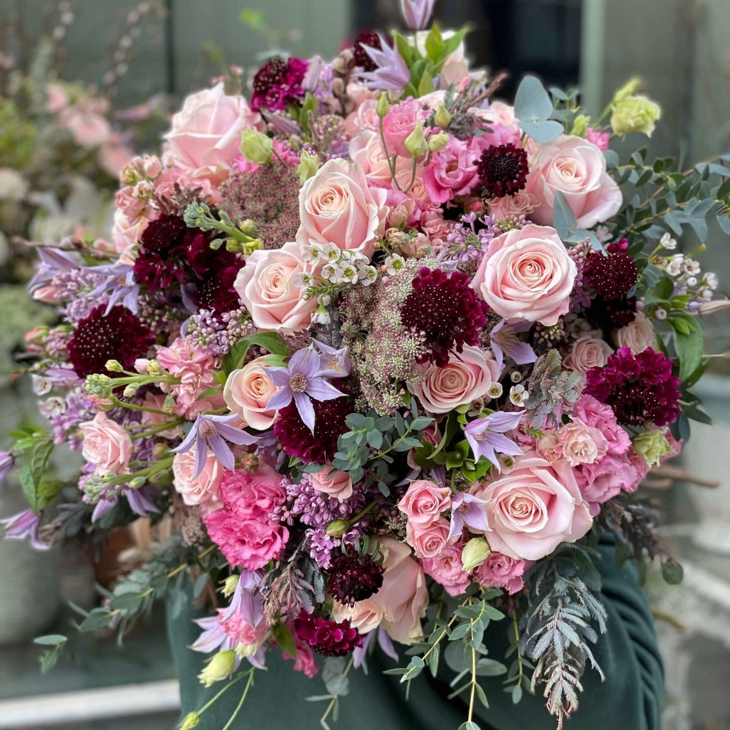Radiant Pastels Mother's Day bouquet by Pulbrook & Gould — pink roses, scabiosa and clematis with blush and burgundy tones, hand-held