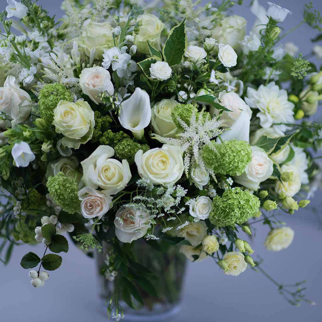 Timeless Whites Mother's Day bouquet by Pulbrook & Gould — white roses, calla lilies and lisianthus with soft green foliage